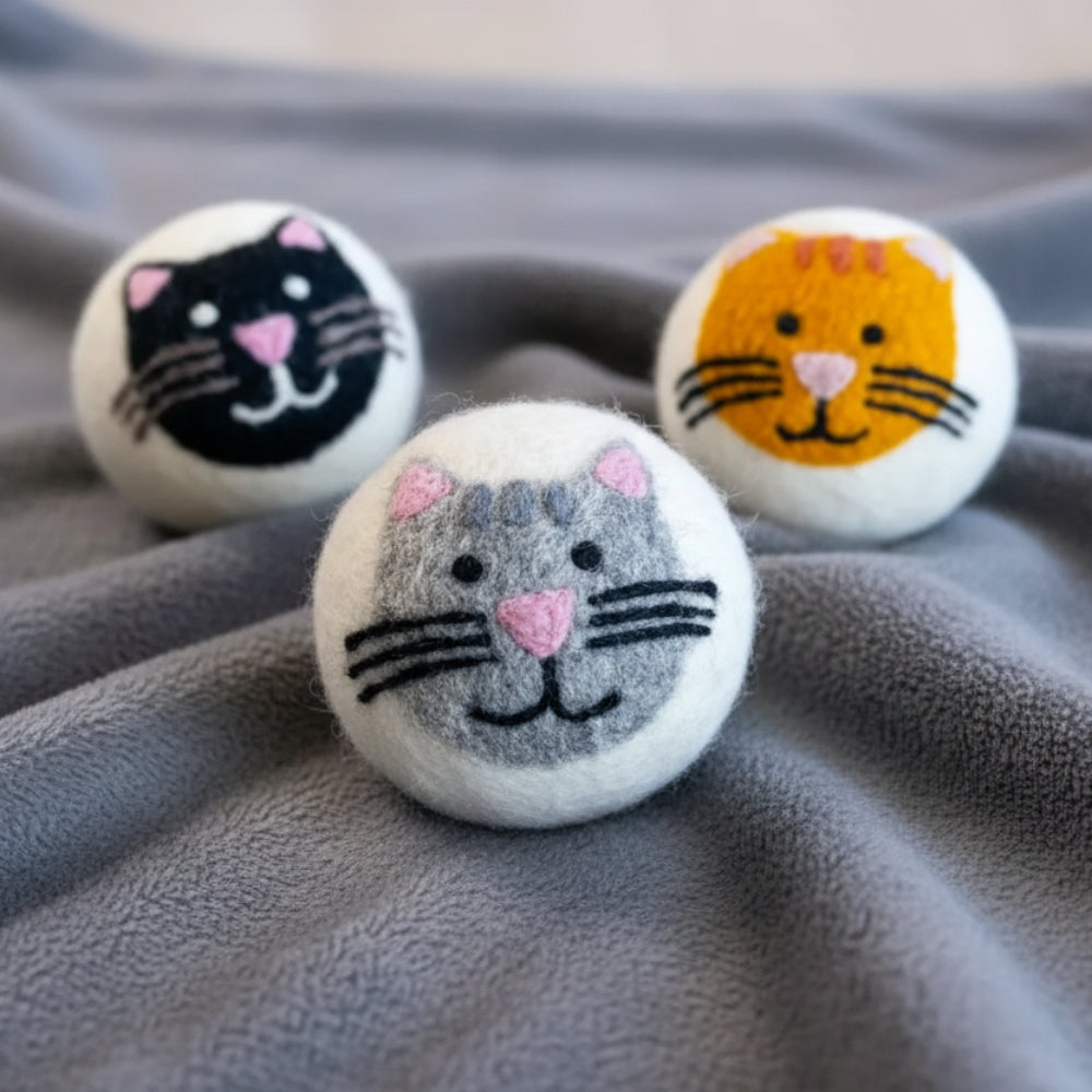 Cute wool dryer balls as house cats in orange, grey, black with pink ears