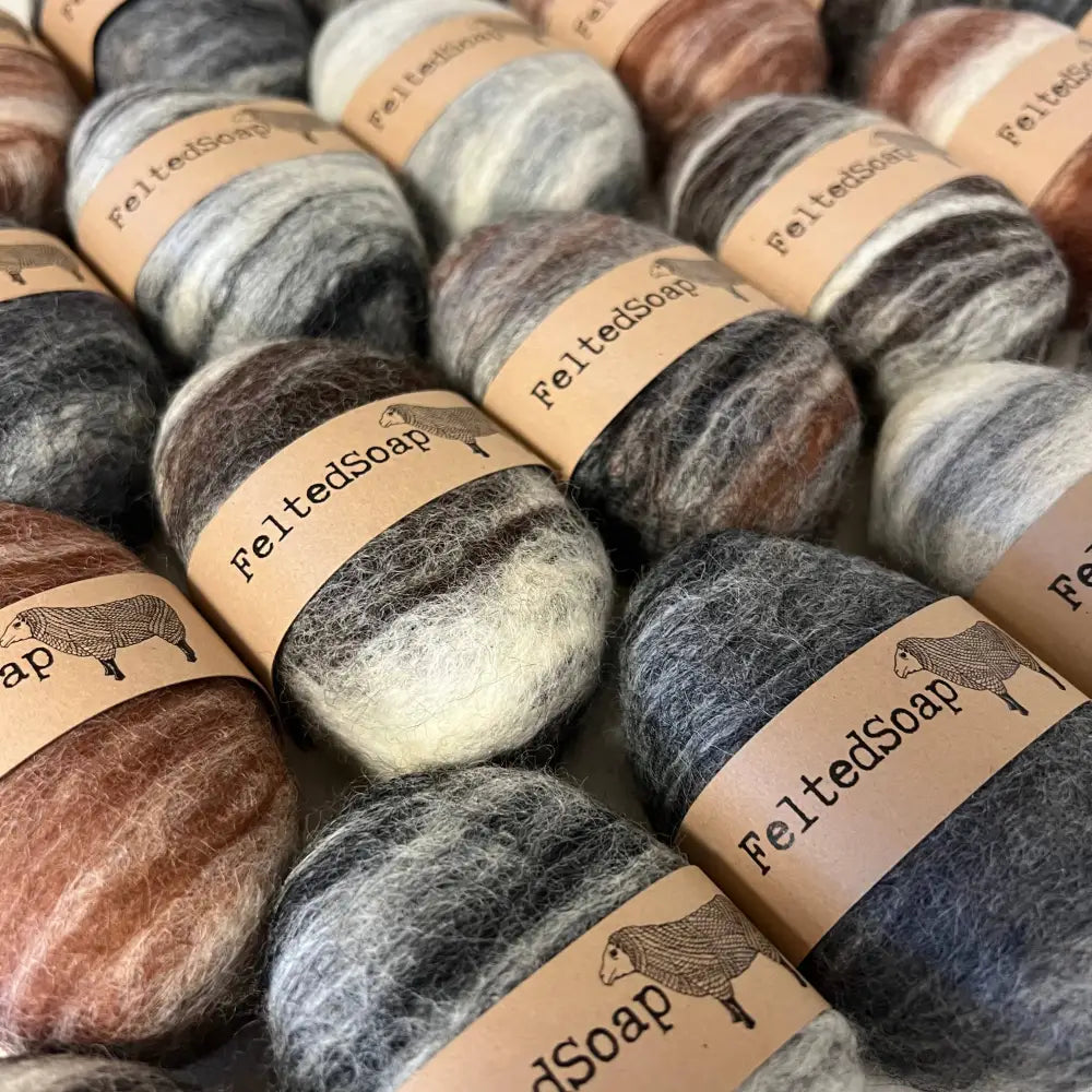 Bars of soap wrapped in natural tones colored wool.