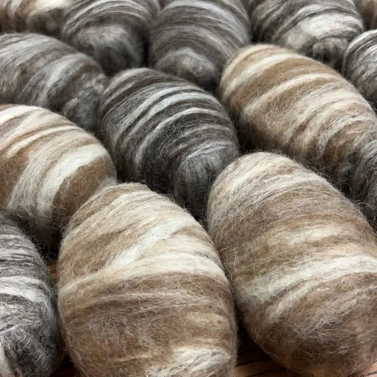 Bars of soap wrapped in natural tones colored wool.